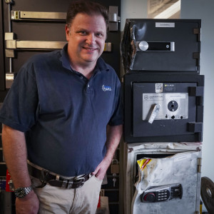 Nick Reed with safes that have been broken into, demonstrating that quality does impact security.